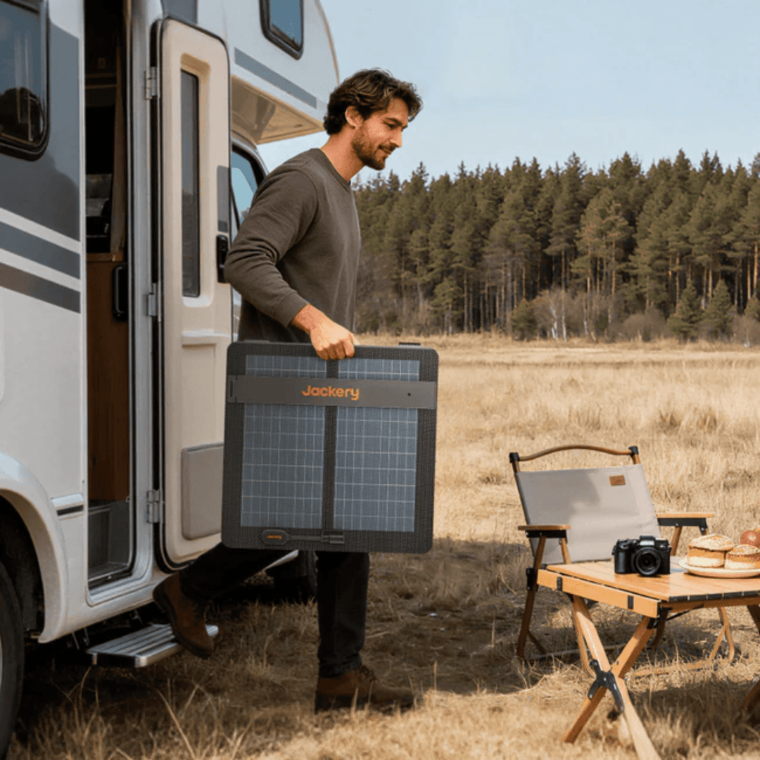 Jackery 100W Air Solar Panel for outdoor camping, portable solar power charger with flexible, lightweight design in outdoor setting