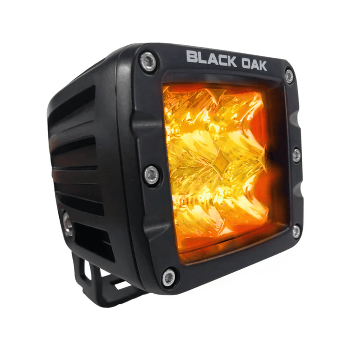 Black Oak LED 2-inch Amber Pod light with 3W Osram flood optics and black housing, designed for durable outdoor illumination.
