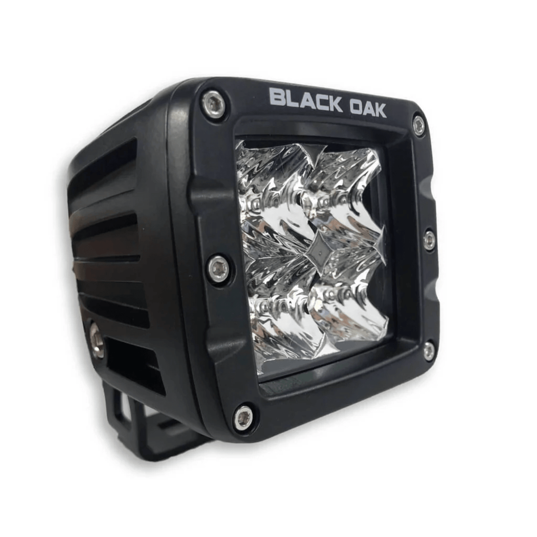 Black Oak LED 2-inch Amber Pod light with 3W Osram flood optics and black housing, designed for outdoor or automotive lighting.