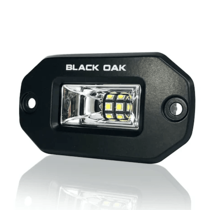 Black Oak LED 2-inch black marine flush mount spreader light with black housing, ideal for boat lighting applications.