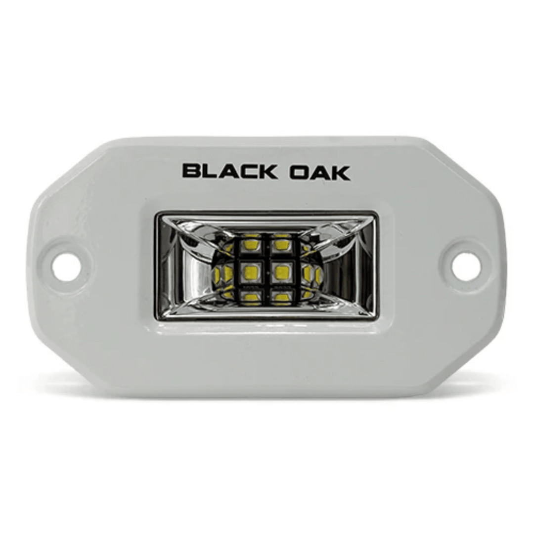 Black Oak LED 2-inch marine flush mount spreader light with white housing, ideal for boat lighting applications.
