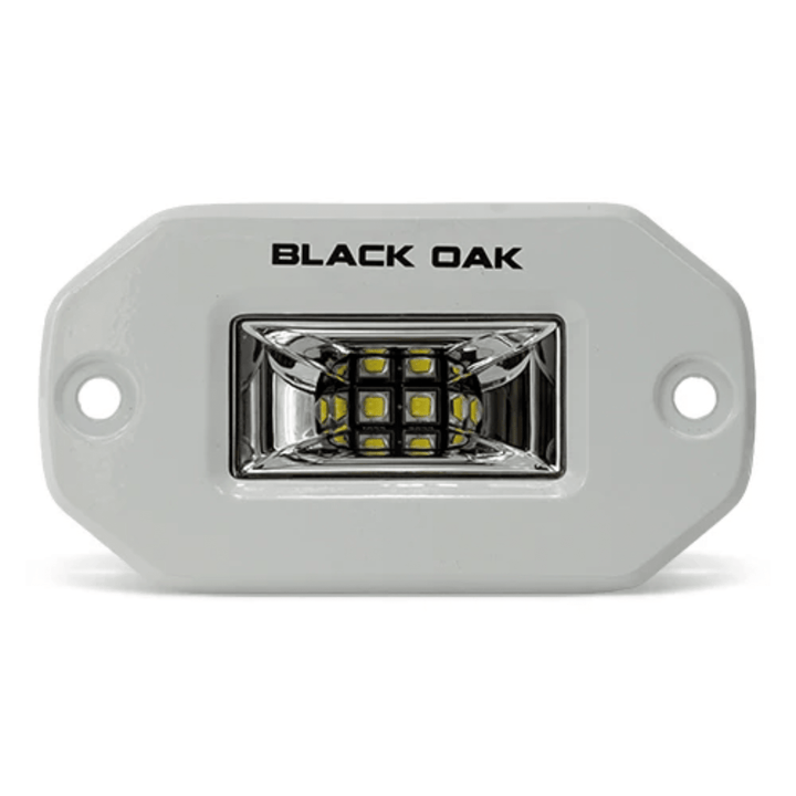 Black Oak LED 2-inch marine flush mount spreader light with white housing, ideal for boat lighting applications.