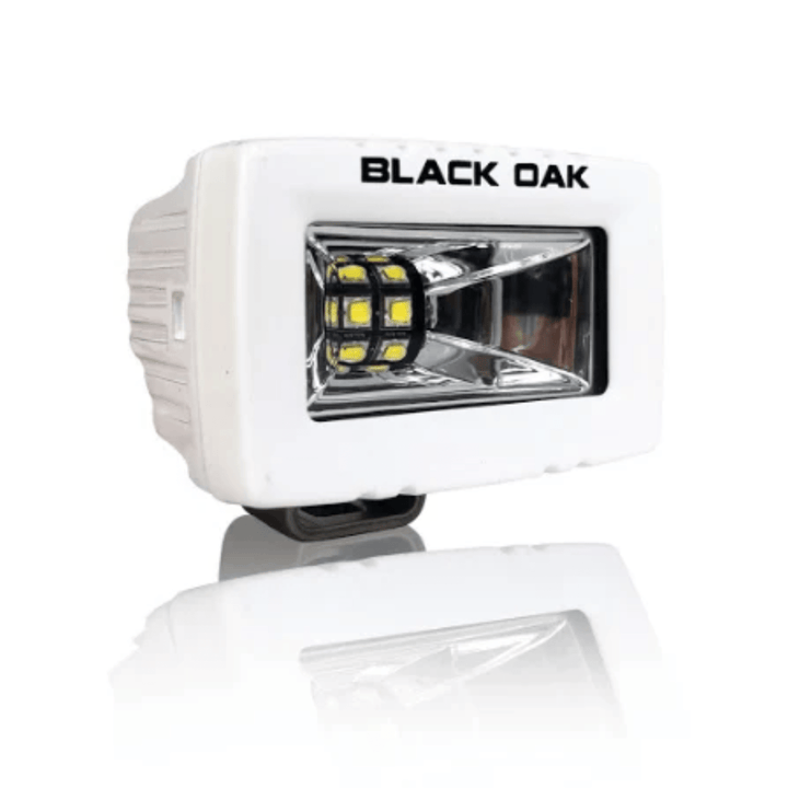 Black Oak 2-inch Marine LED flood spreader light with white housing and scene optics, ideal for underwater or boat lighting.