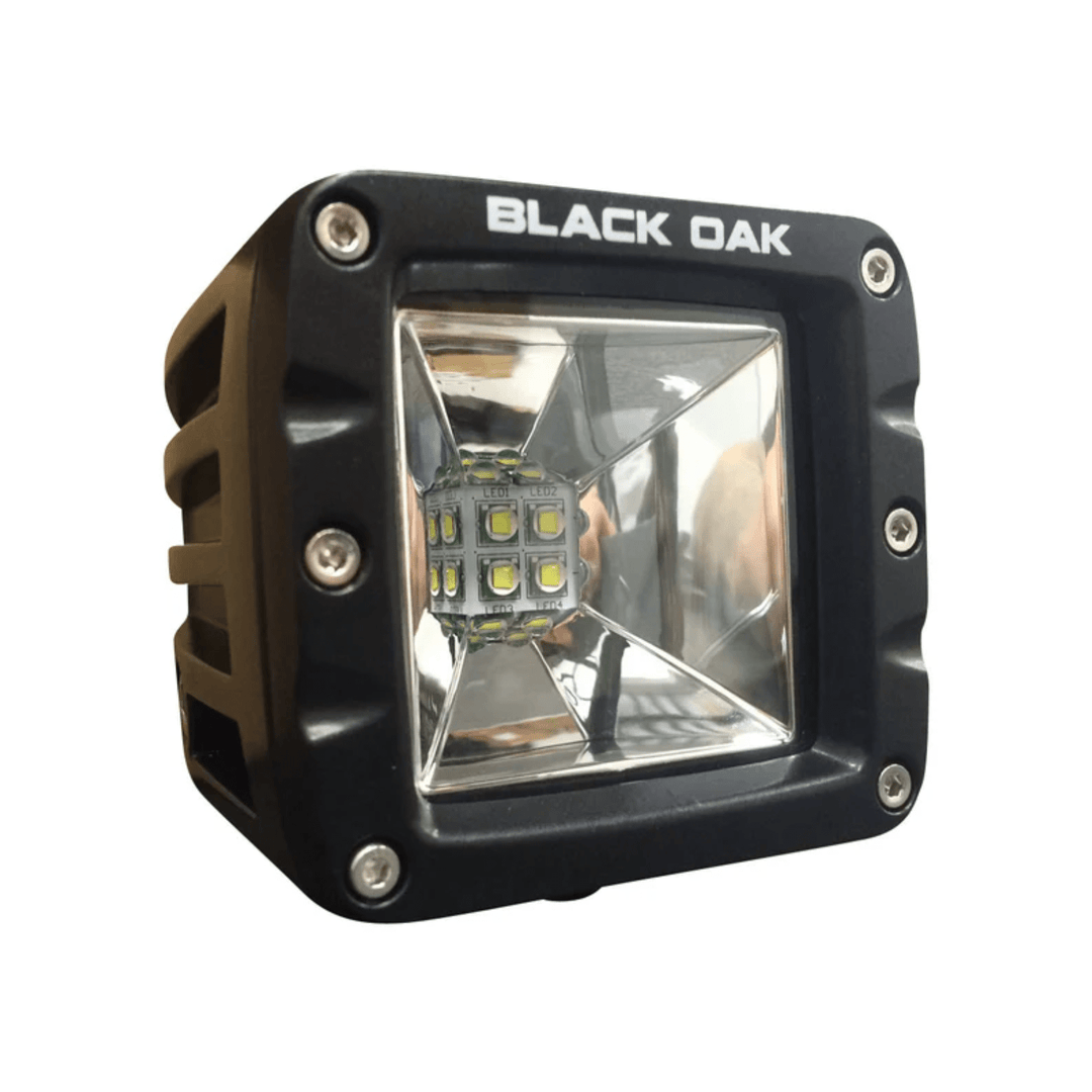 Black Oak LED 2-inch Scene Optics Pod with 10W Cree bulb and black housing, providing focused lighting.
