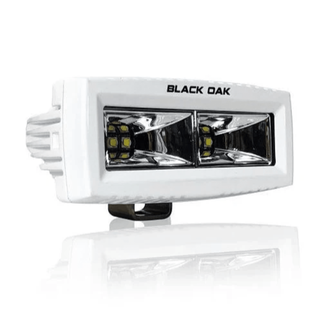 Black Oak 4-inch marine LED spreader light with flood scene optics, white housing, ideal for boat lighting applications.
