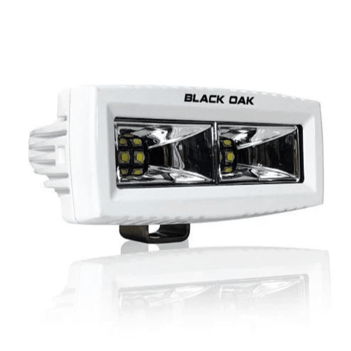 Black Oak 4-inch marine LED spreader light with flood scene optics, white housing, ideal for boat lighting applications.
