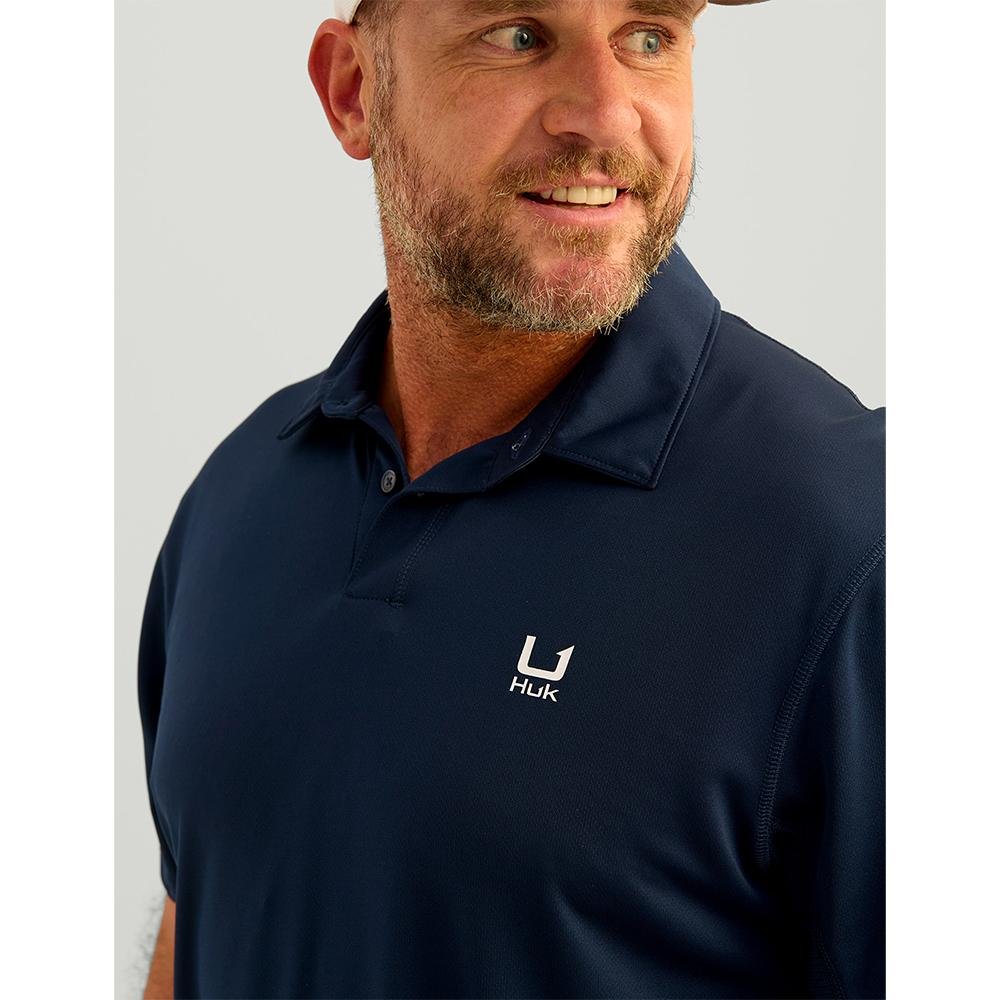 Chattanooga Huk Icon Polo Naval Academy short sleeve shirt in navy color, featuring a classic polo design and branding.