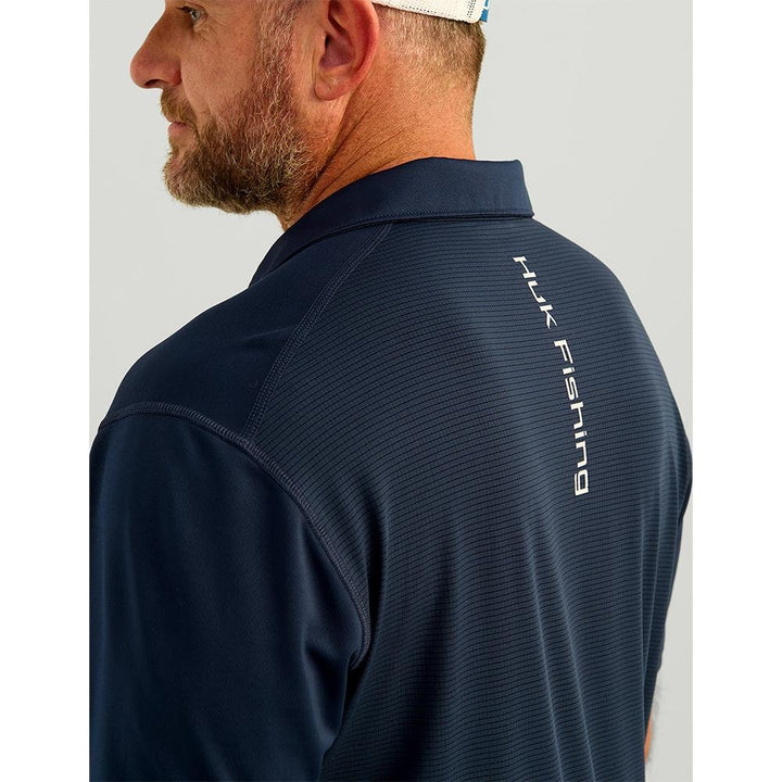 Chattanooga Huk Icon Polo Naval Academy short sleeve shirt in navy, with collar and logo detail, displayed on a plain background.