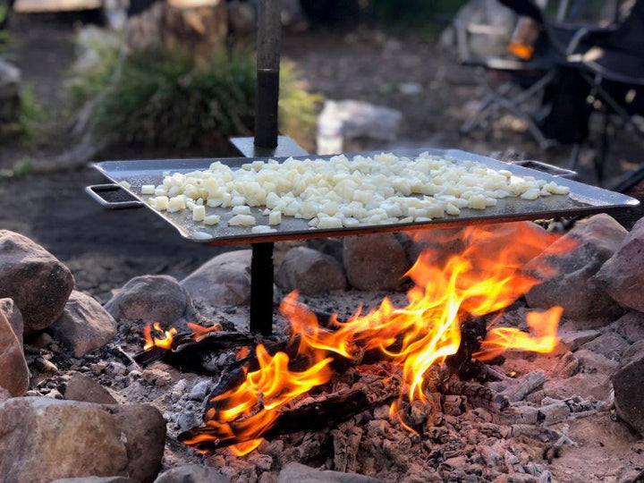Chattanooga Camp Chef Mountain Man Grill portable outdoor cooking griddle made of durable steel for camping and outdoor grilling.