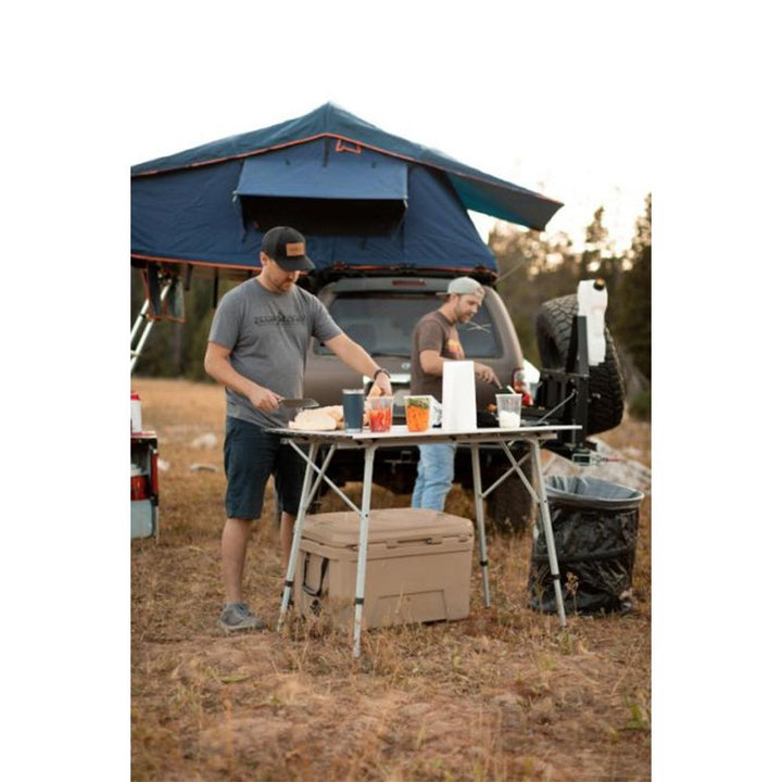 Chattanooga Camp Chef Mountain Series Mesa outdoor camp table with adjustable height and sturdy design, suitable for camping and outdoor activities.