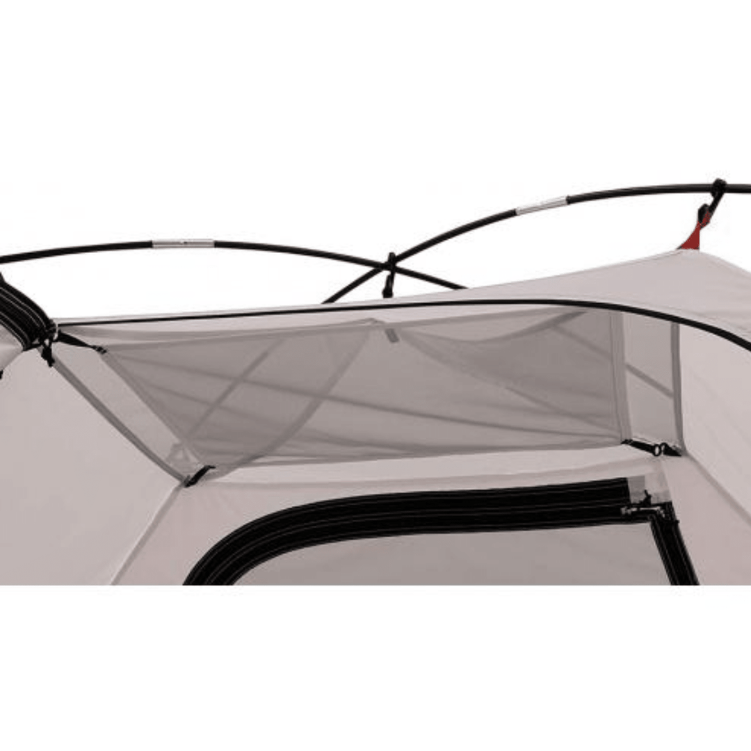 Chattanooga Alps Mountaineering Taurus 2-person polyester and fiberglass camping tent set up outdoors with rainfly and mesh windows.