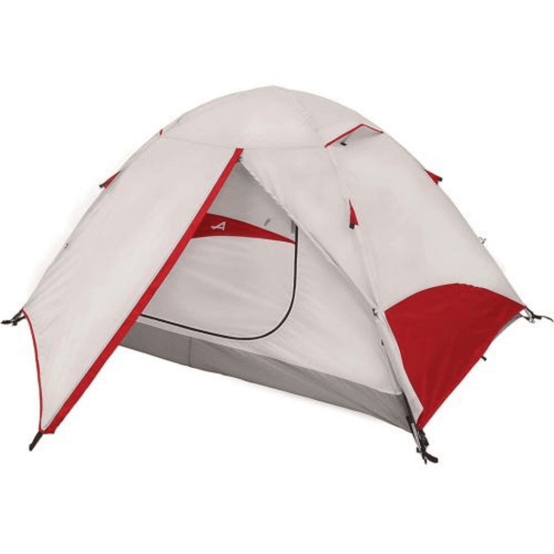 Chattanooga Alps Mountaineering Taurus 4-person polyester and fiberglass camping tent set up outdoors with rainfly and mesh windows.