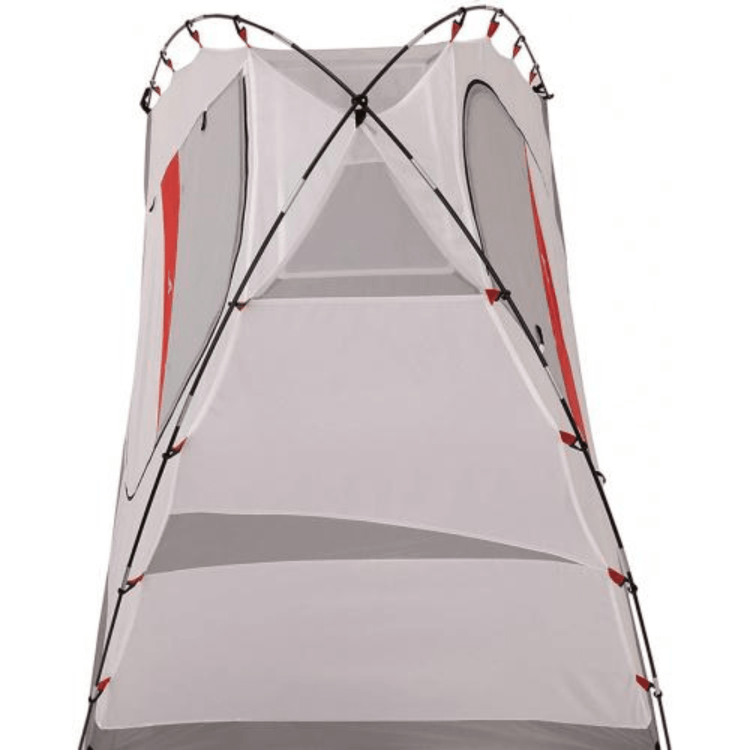 Chattanooga Alps Mountaineering Taurus 4-person polyester and fiberglass camping tent set up outdoors, showing its rainfly and mesh windows.