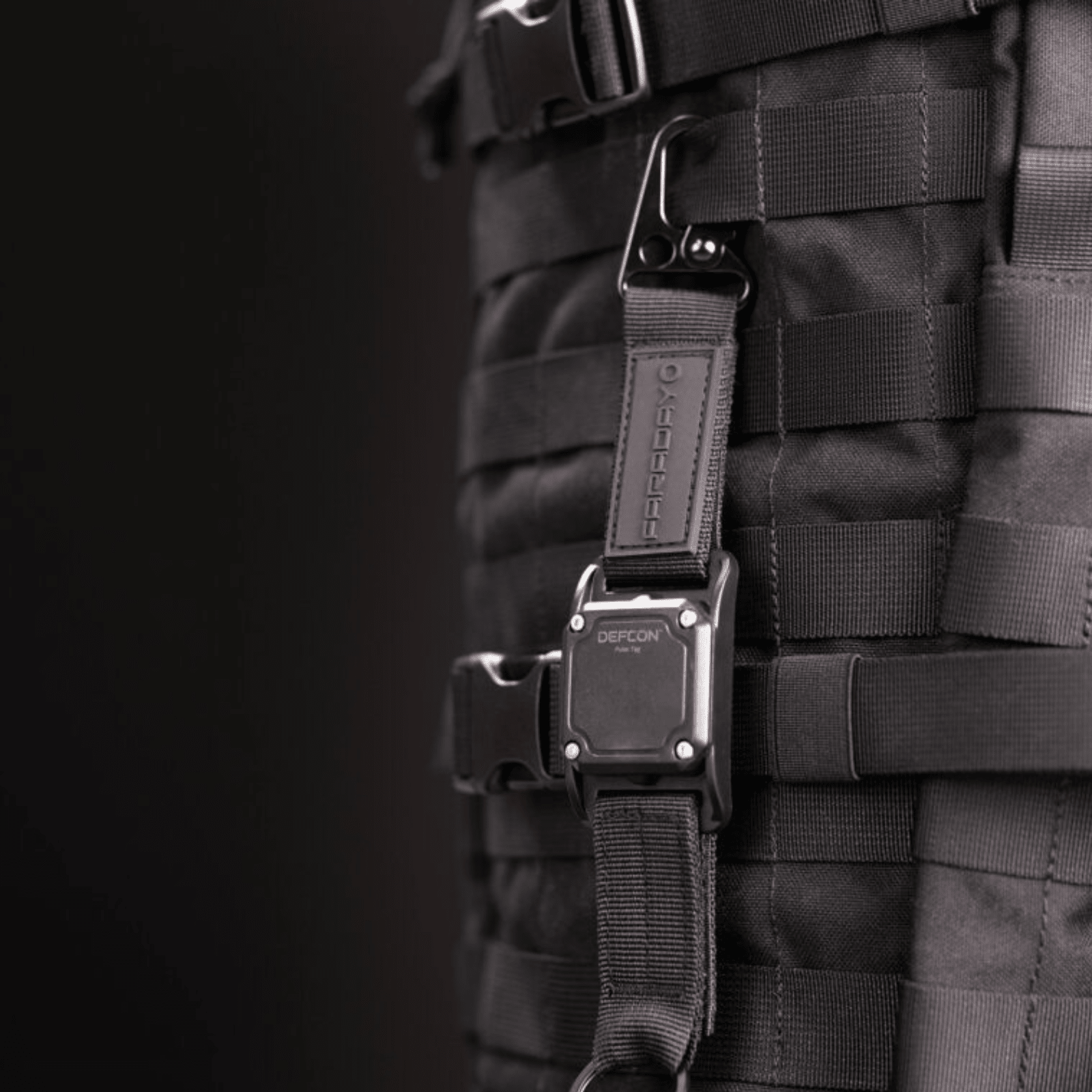 Faraday DEFCON Pulse Tag personal wearable EMP detection system in black with alert indicator, designed for portable EMP threat detection.