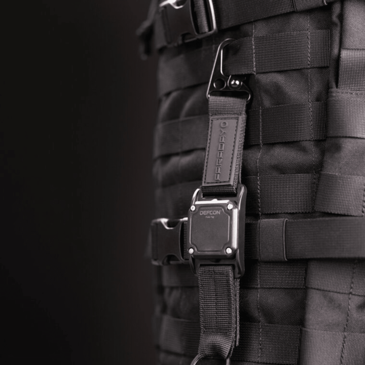 Faraday DEFCON Pulse Tag personal wearable EMP detection system in black with alert indicator, designed for portable EMP threat detection.