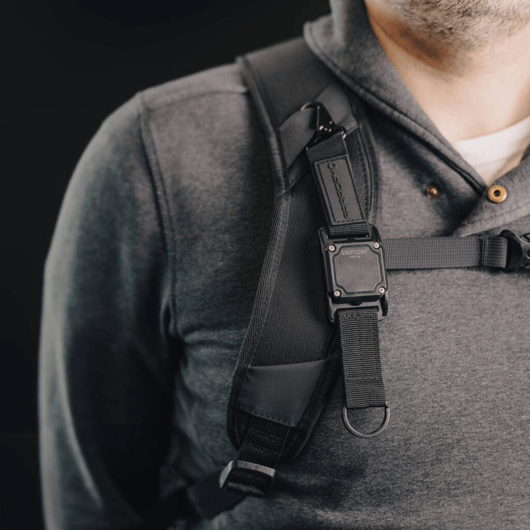 Faraday DEFCON Pulse Tag personal wearable EMP detection system showing a compact device with display and clip for easy attachment