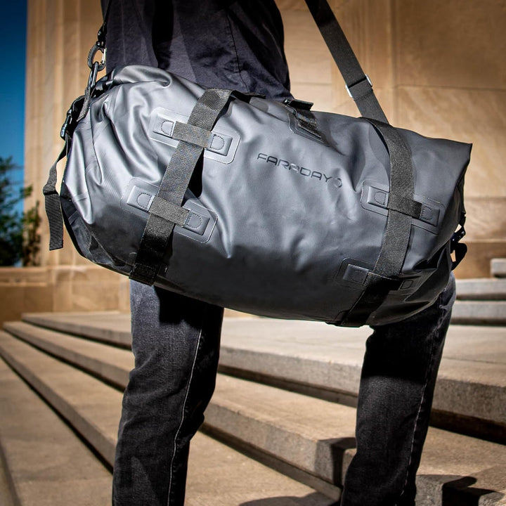 Faraday Dry Duffel Bag in Stealth Black showing durable fabric, 55L size, with RF/EMF shielding features and sturdy handles.