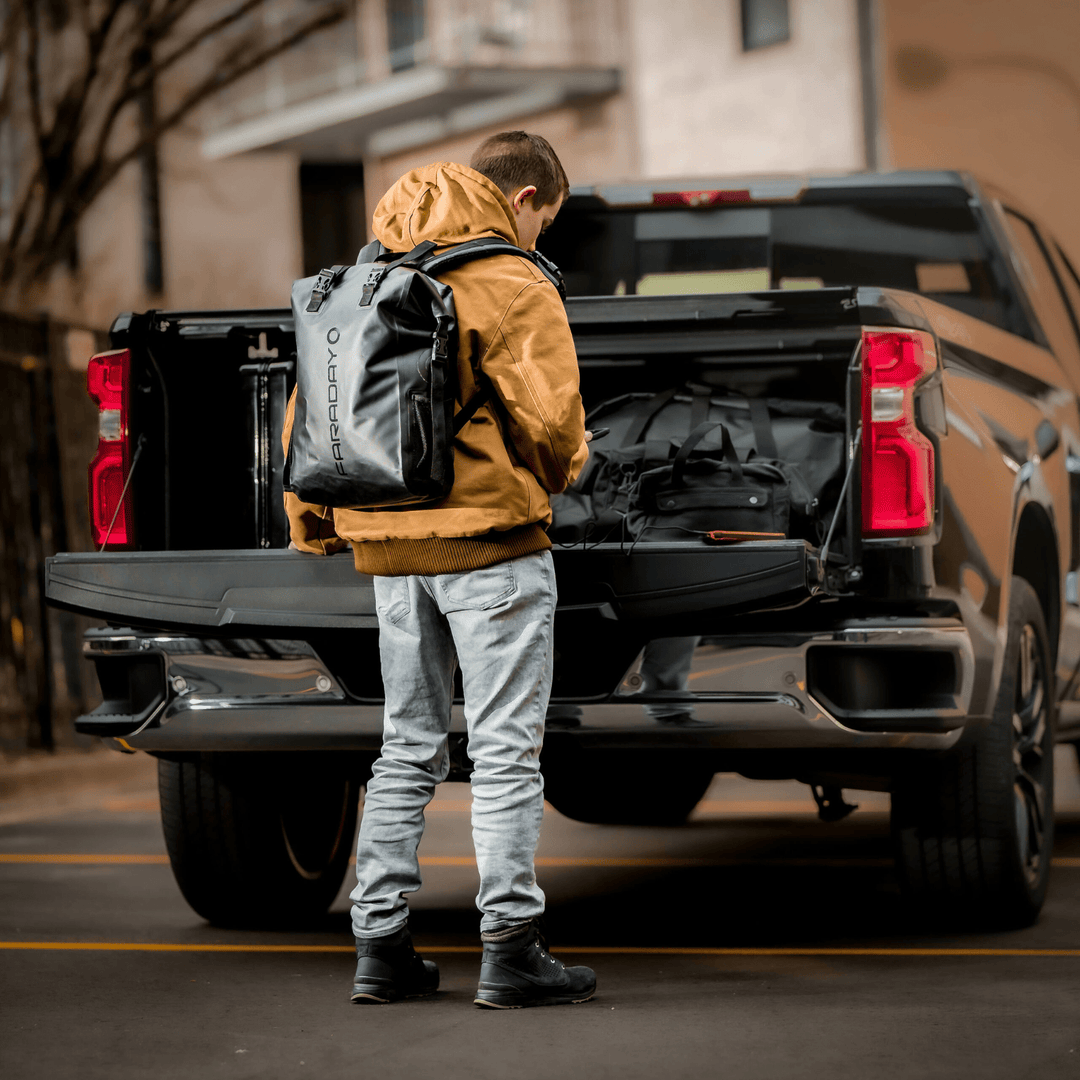 Faraday waterproof dry bag backpack with 3-piece NX3 kit for travel, offering shielding and secure storage for electronic devices.