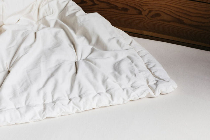 Holy Lamb Wool Comforter in queen size, showcasing soft, light wool filling and a cozy, breathable outer fabric for cool comfort.