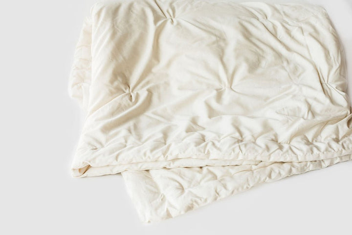 Holy Lamb Wool Comforter in queen size, light and cool, showcasing soft, cozy wool filling and a clean, inviting bedding design.