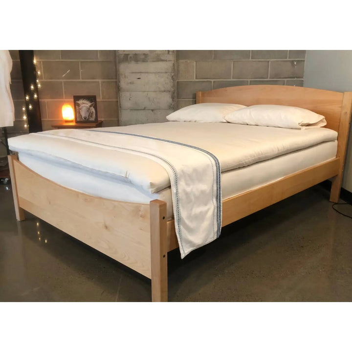 Holy Lamb Wool and Latex Mattress Topper in full size, showing plush wool and latex layers on a bed with white sheets.