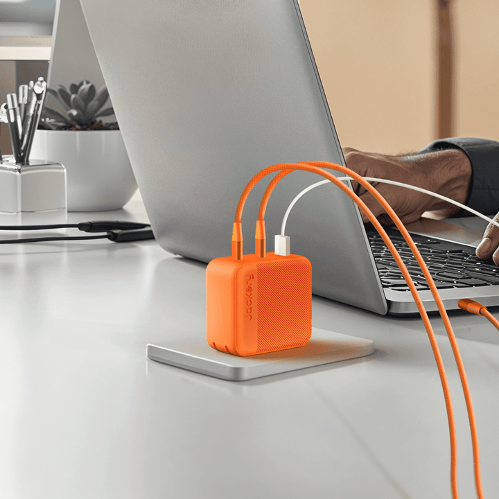 Jackery 102W GaN 3-port fast charger with compact design, multiple USB ports, and sleek black finish.