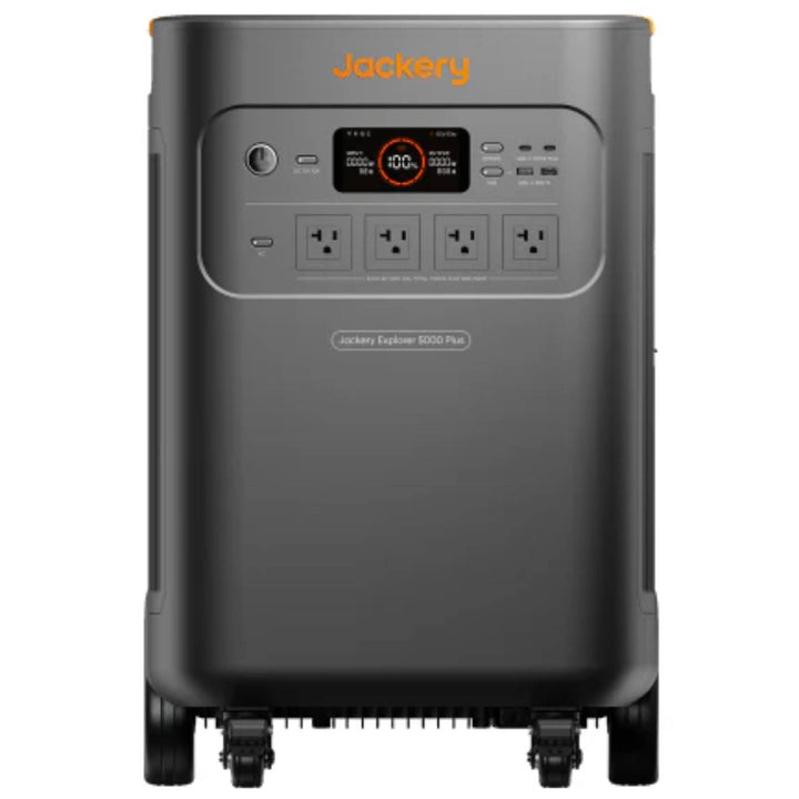 Jackery Whole-Home Backup Kit 5000 Plus portable power station with multiple outlets and digital display showing battery status.