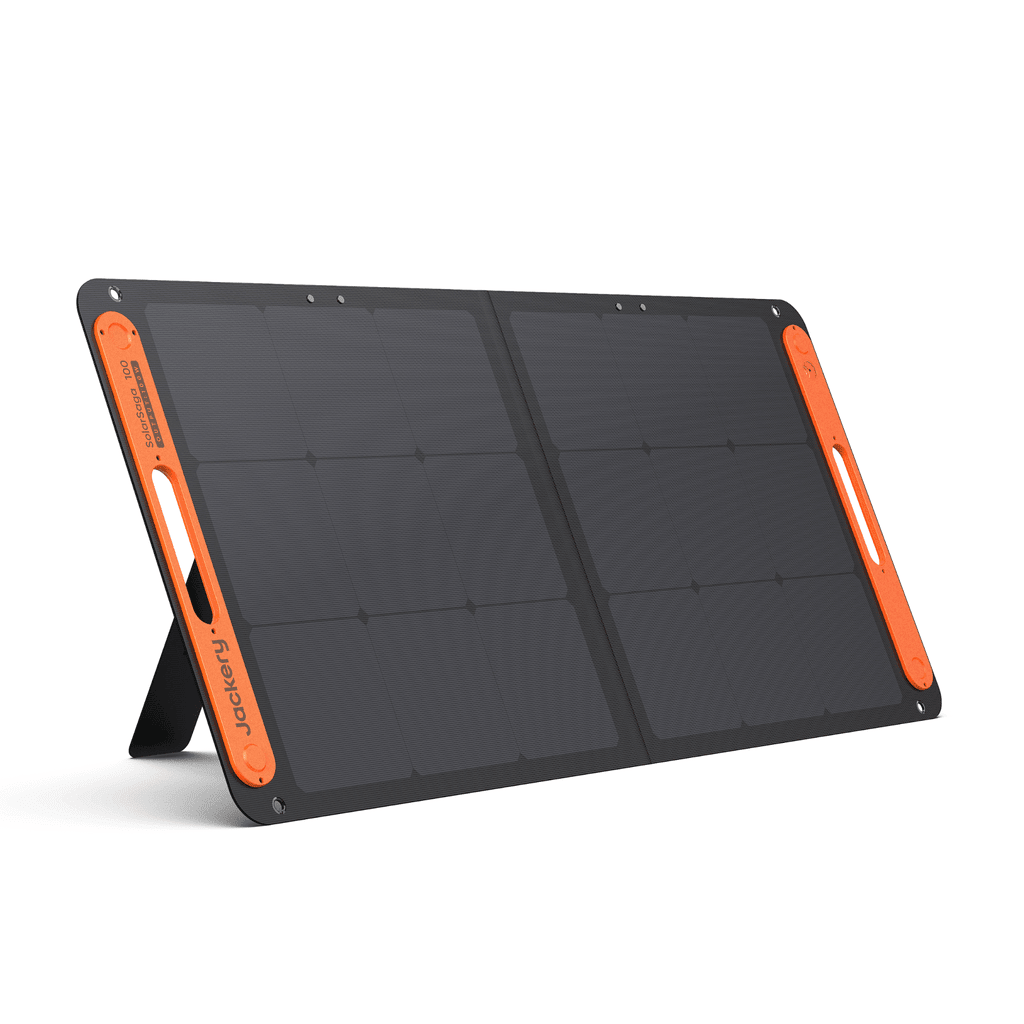 Jackery SolarSaga 100W solar panel outdoors showing its black photovoltaic surface and compact design for portable solar power.
