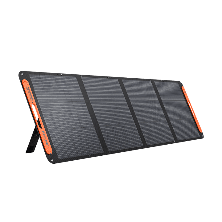 Jackery SolarSaga 200W portable solar panel outdoors, showing black flexible solar cells and adjustable stand for camping or RV use