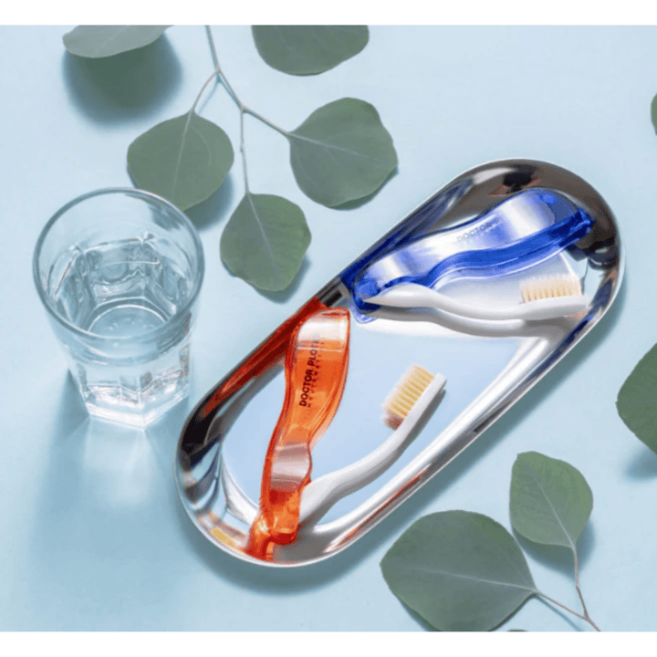 MHP travel folding toothbrush with compact design, featuring a blue handle and foldable head for portable dental hygiene.